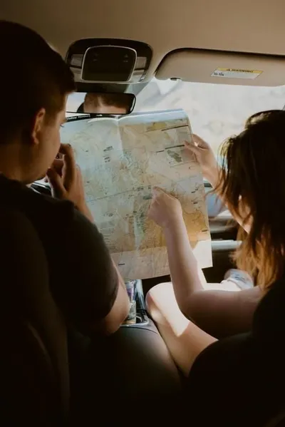 Two people planning a route over a paper map